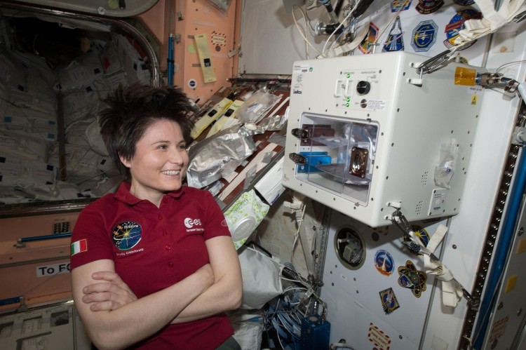 ASA Image: ISS043E160068 - ESA Astronaut Samantha Cristoforetti stands next to the ISSpresso machine. 