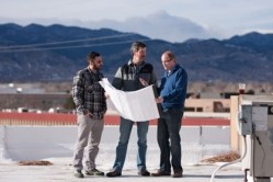 Superior Ecotech's co-founders Daniel Higgs, right, and Phil Calabrese, left, discuss plans for the algae greenhouse with Upslope Brewery's founder Matt Cutter. 