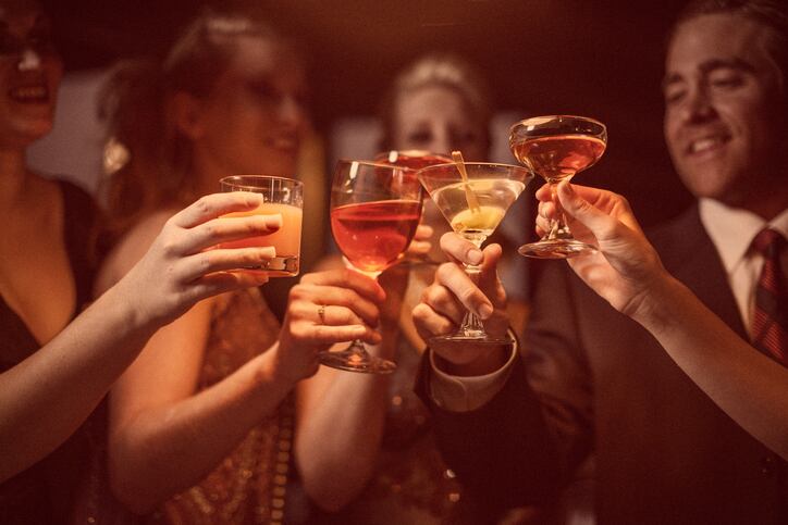 A man and four women are celebrating their success.