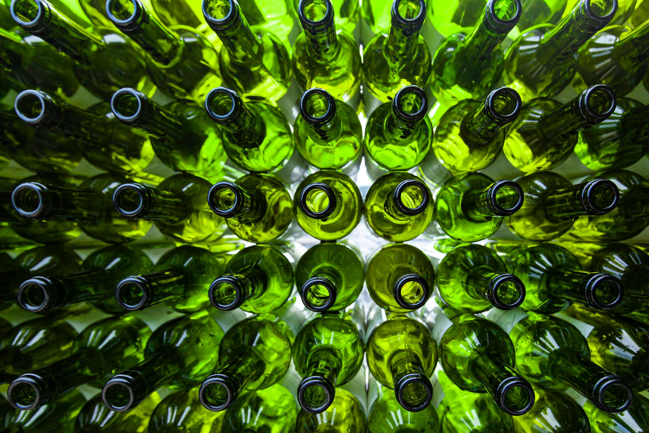 A large number of  recycling  glass bottles stacked in an orderly manner, backlit shots of only transmitted light in the early morning