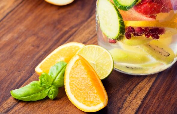 Infused water for detoxing your body with cucumber, strawberries, basil, lime, pomegranate seeds, oranges and lemons