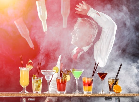 Adult bartender juggling bottle, preparing various cocktails - Margaritas, Mojito, Cosmopolitan, Grasshopper, Bloody Mary etc. About 40 years old, Caucasian man.