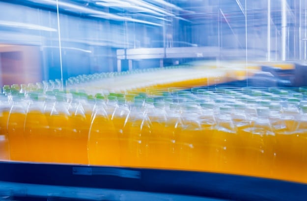 Beverage factory interior. Conveyor with bottles for juice or water. Modern equipments