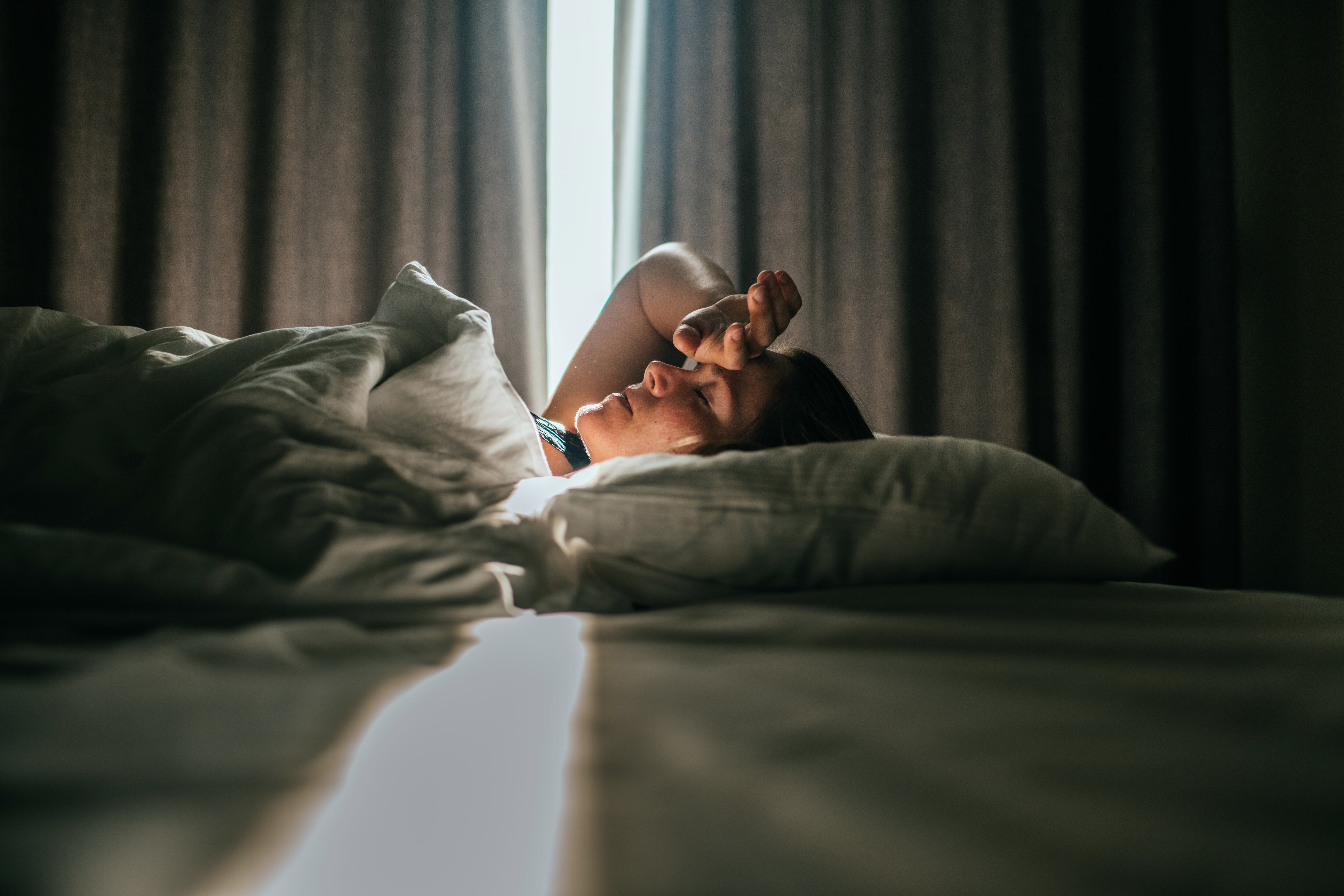 Woman in bed waking up