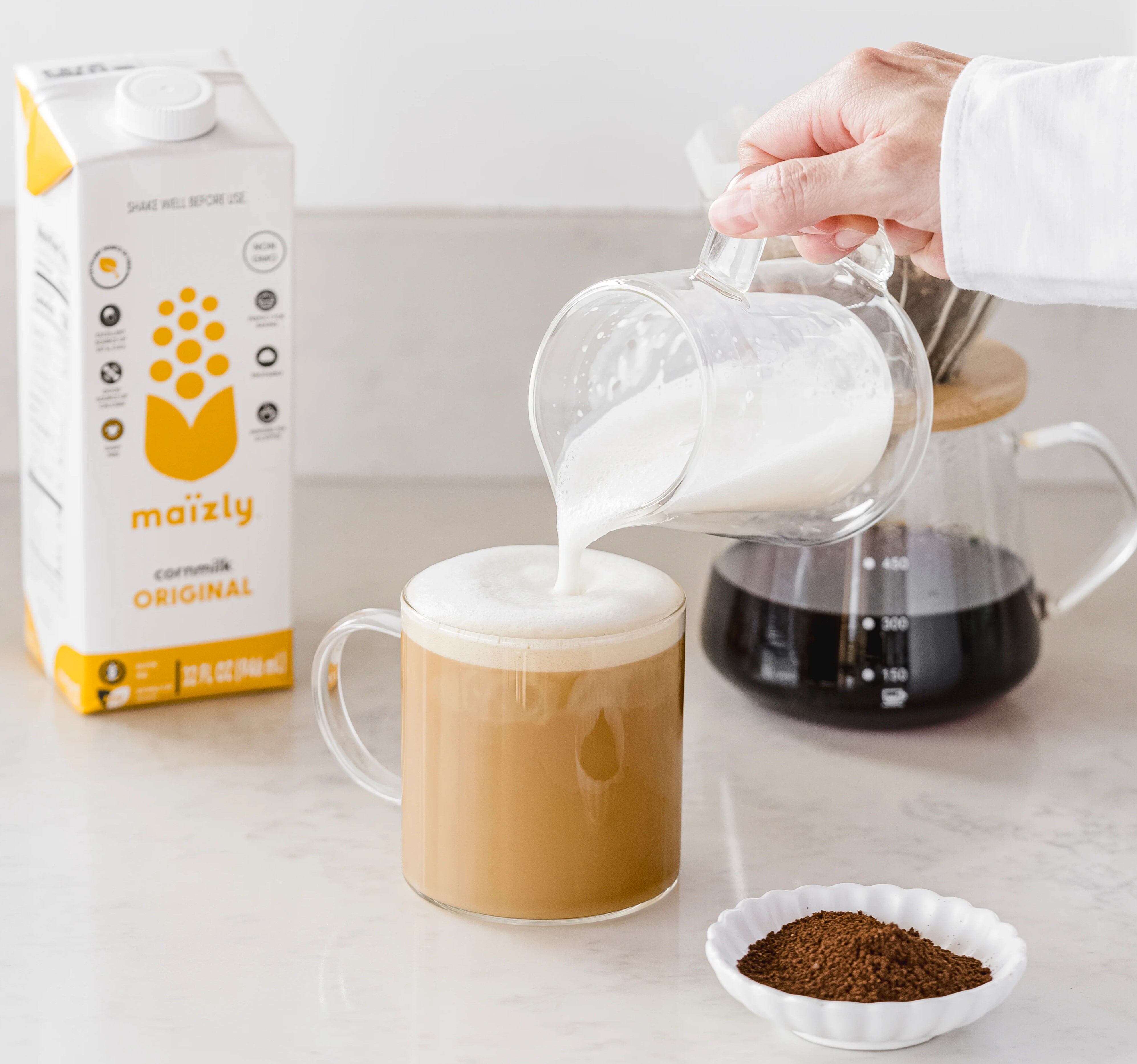 plant-based milk poured into coffee cup