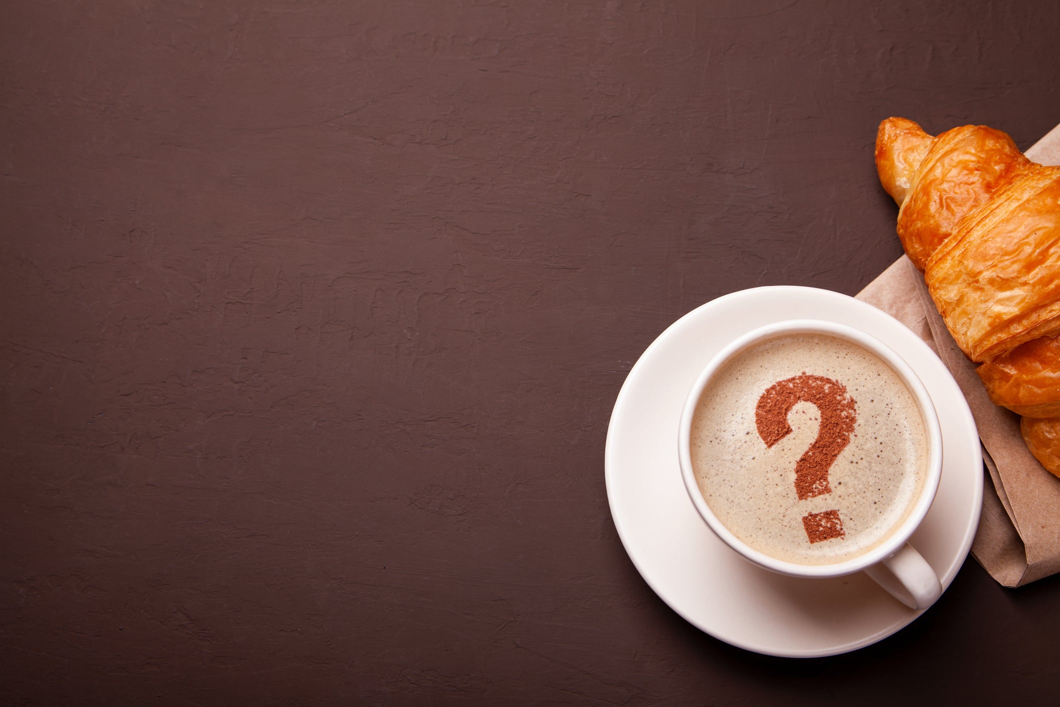 Cup of coffee with question mark  on foam. I like coffee break. FAQ