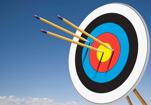 Three pencils stuck in target