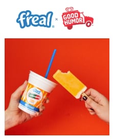 f’real Orange Creamsicle milkshake cup in front of a blending machine.