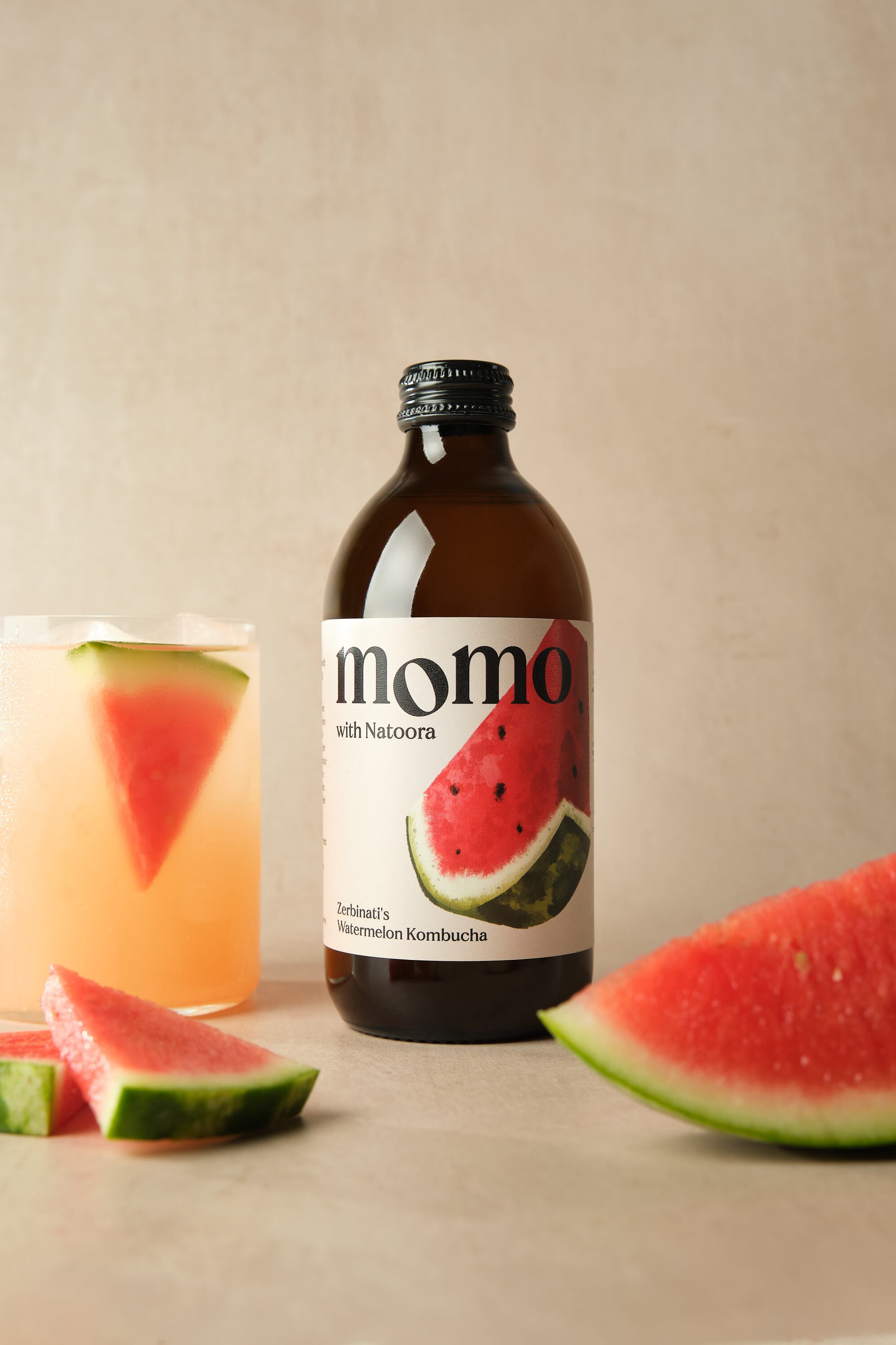 Bottle of MOMO x Natoora Watermelon Kombucha.