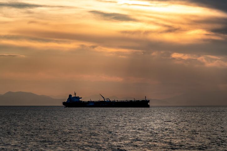 Crude oil tanker in the sea at fiery sunset. Oil and gas industry. Tankers crude oil carrier ship designed for transporting grude oil