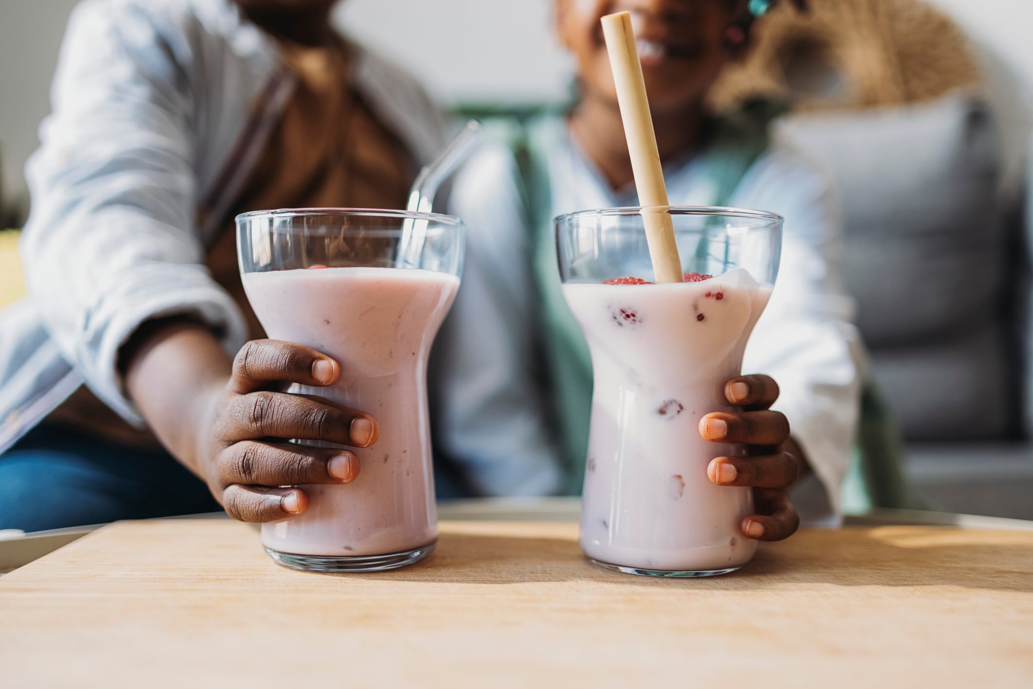 African children holding a strawberry smoothie in hands