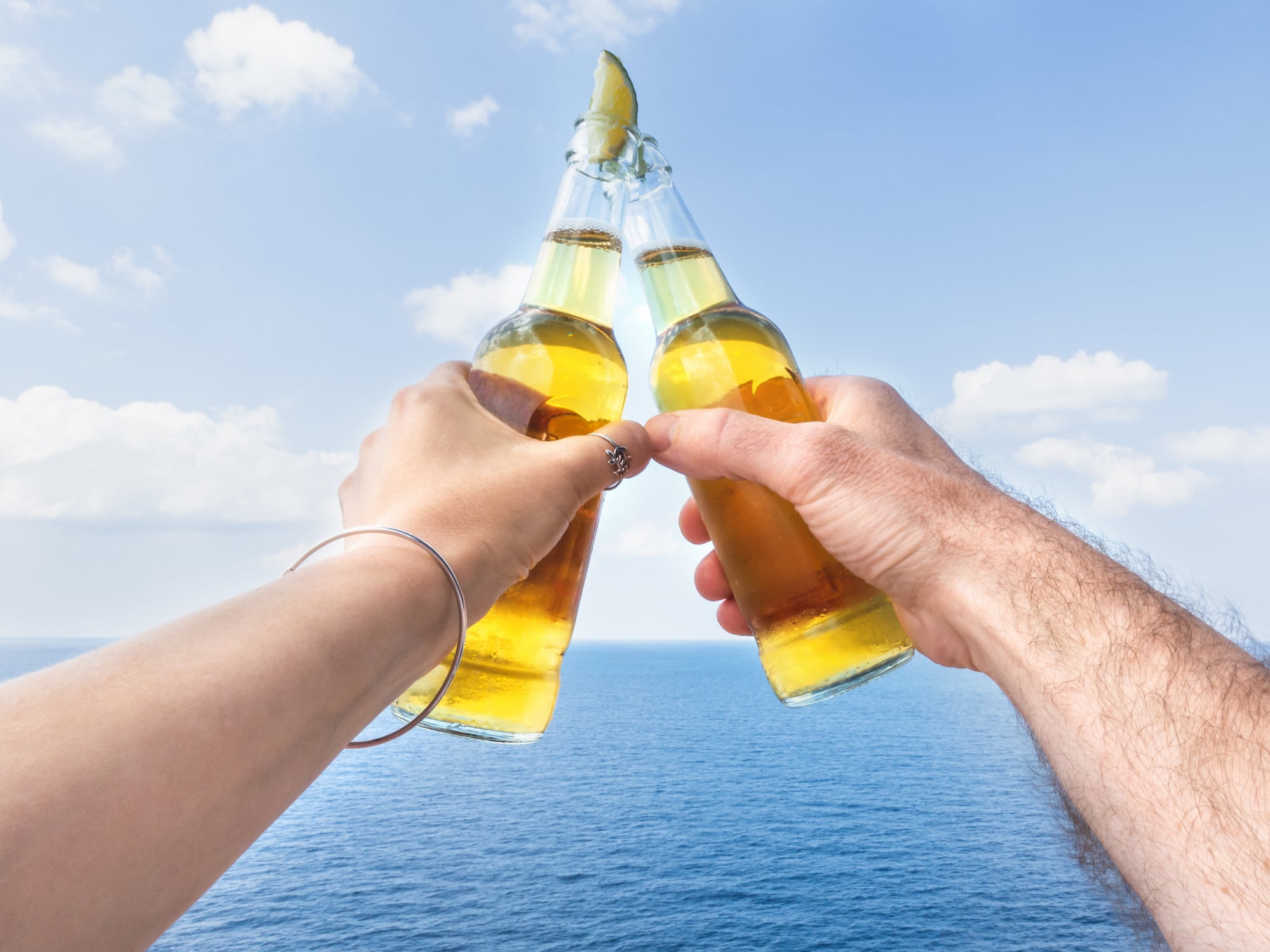 Tow hands holding beer bottles
