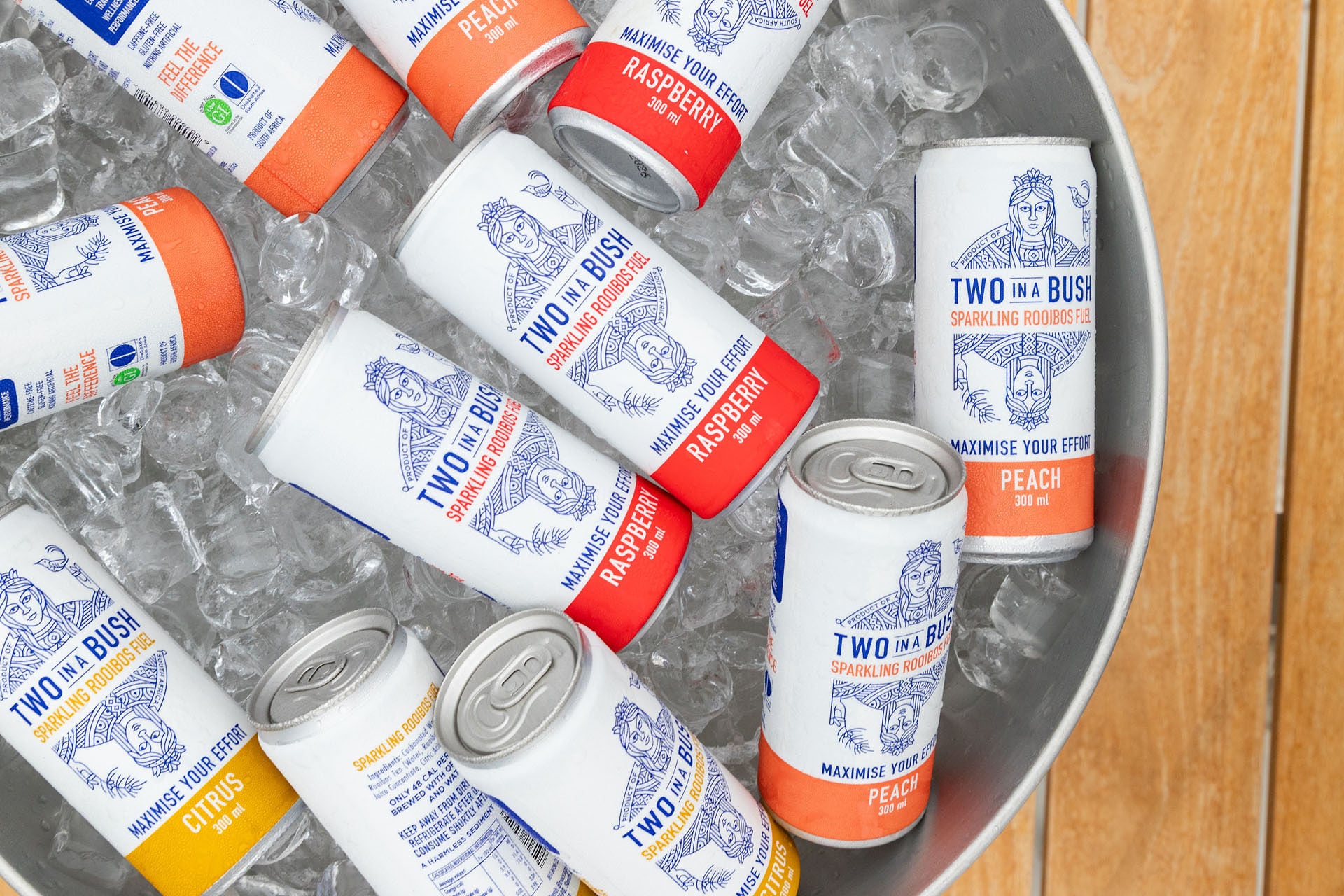 Three cans of rooibos RTDs in Citrus, Peach and Raspberry flavours.