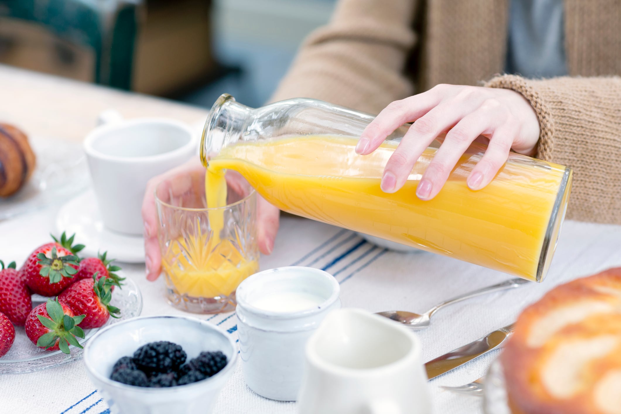 Woman pouring orange juice