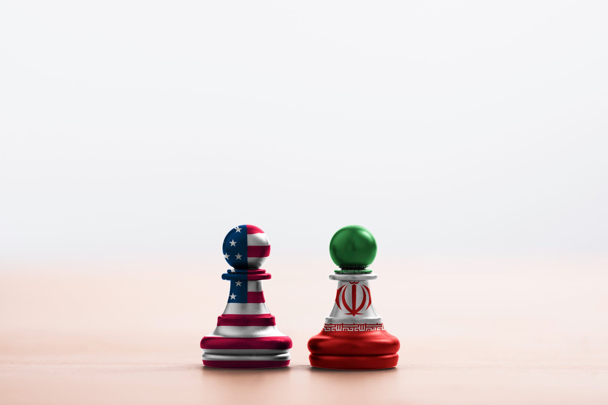 USA flag and Iran flag print screen on pawn chess with soft light background.It is symbol of United state of America and Iran have conflict in nuclear weapons and Strait of Hormuz.