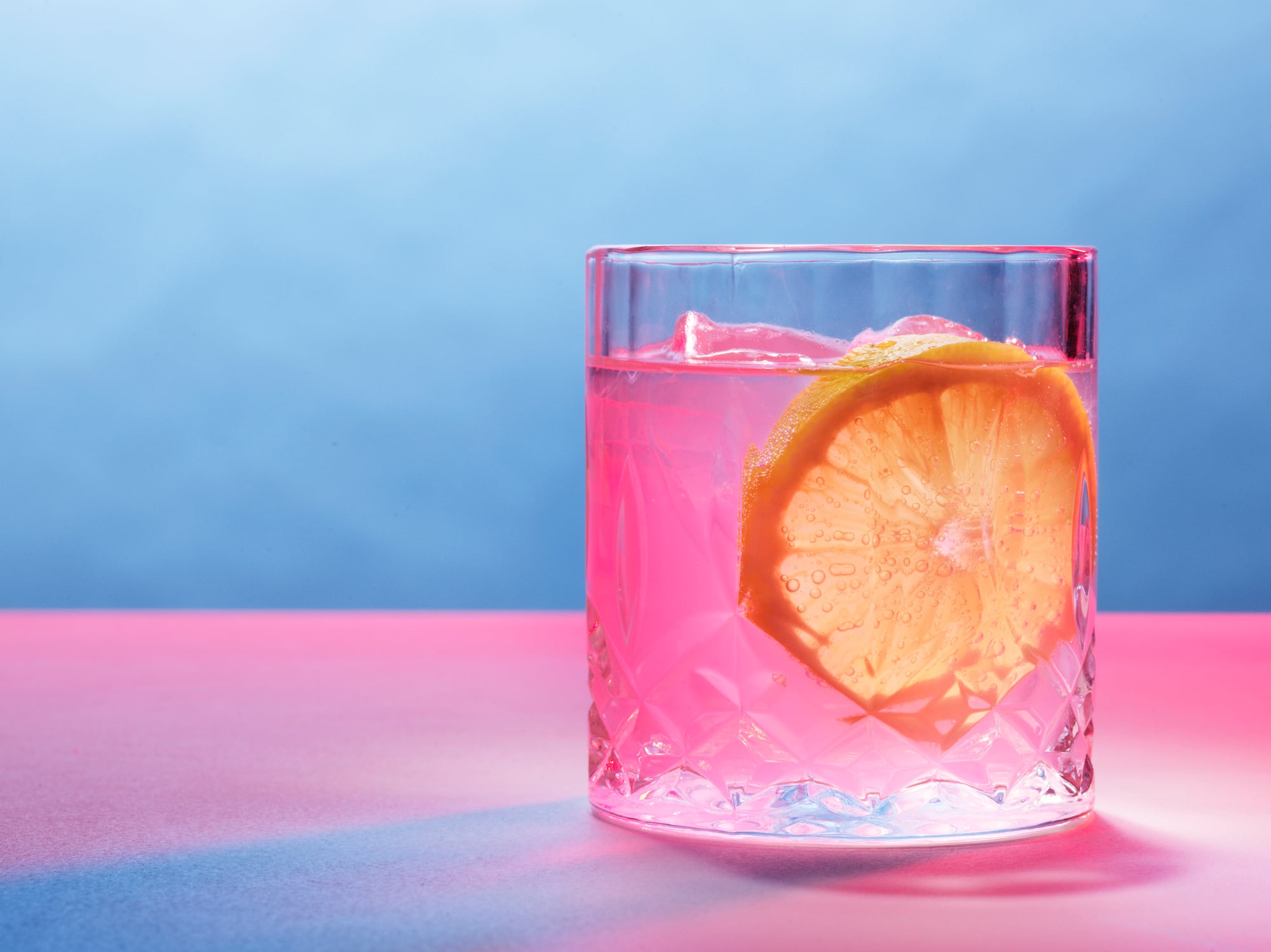 Pink drink with a slice of lemon, stillife