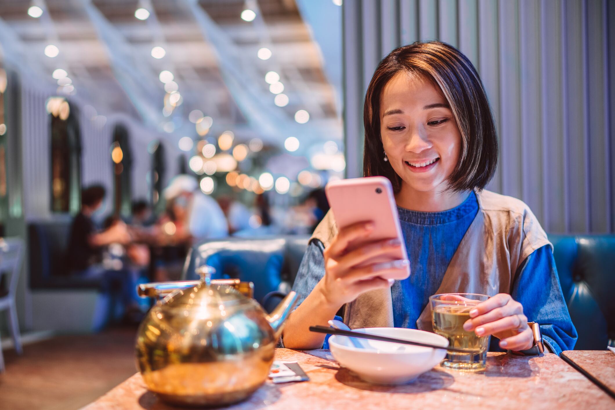 Asian woman enjoying meal in a Chinese restaurant