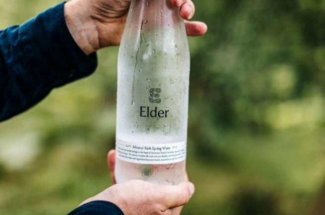 Crates of Elder Water reusable glass bottles ready for delivery and collection.