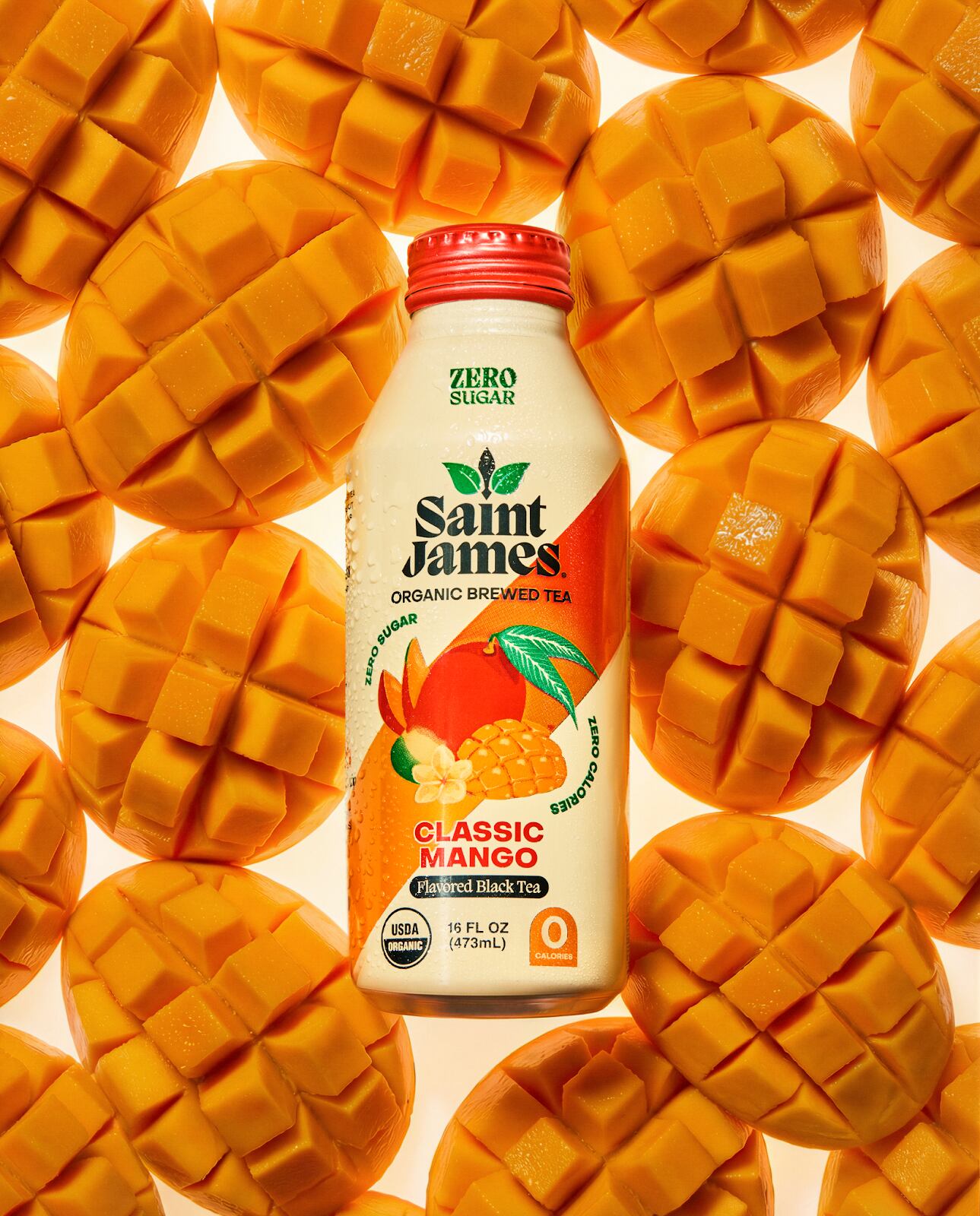 Cans of Saint James Classic Mango iced tea arranged with core range flavours.