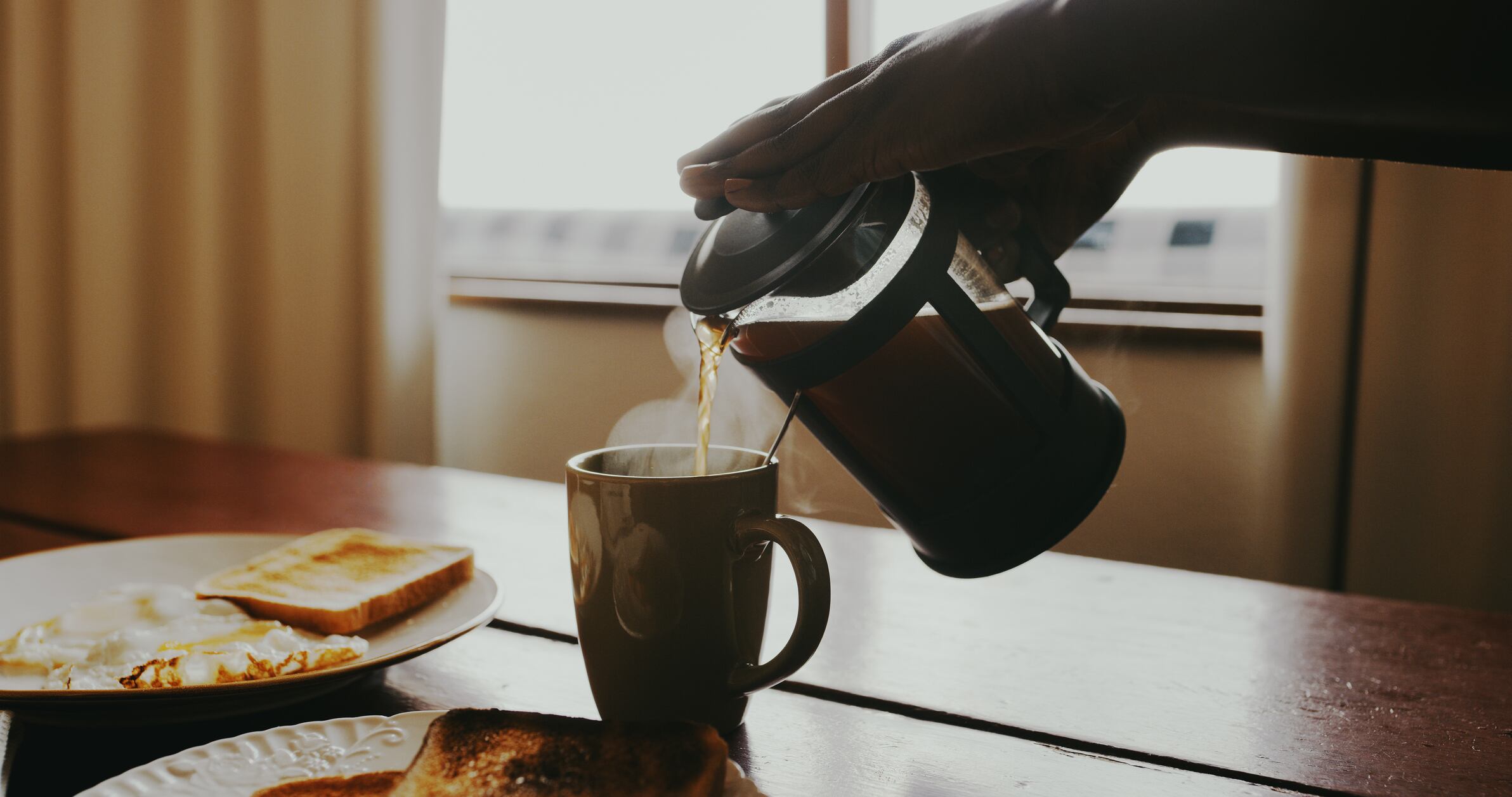 Cropped shot of an unrecognisable woman pouring fresh coffee from a plunger
