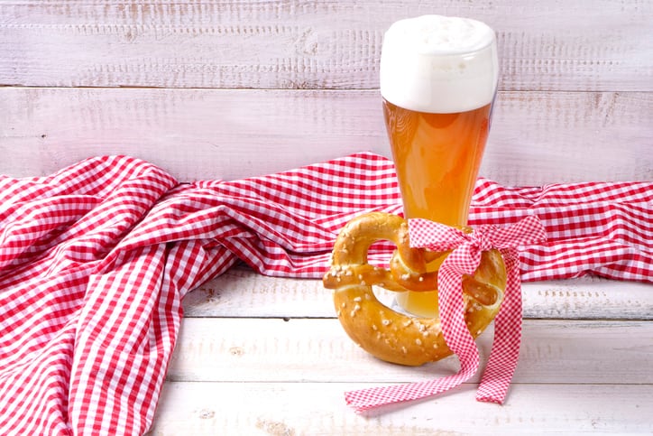 Wheat beer with red and white tablecloth on wooden background