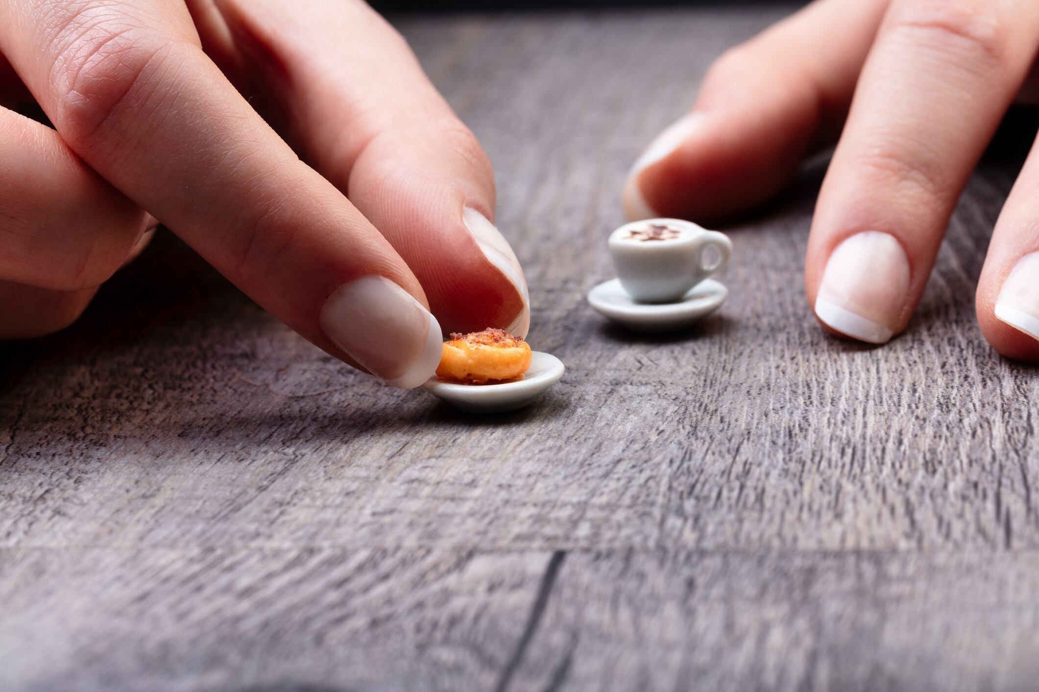 Woman's fingers picking up a micro snack