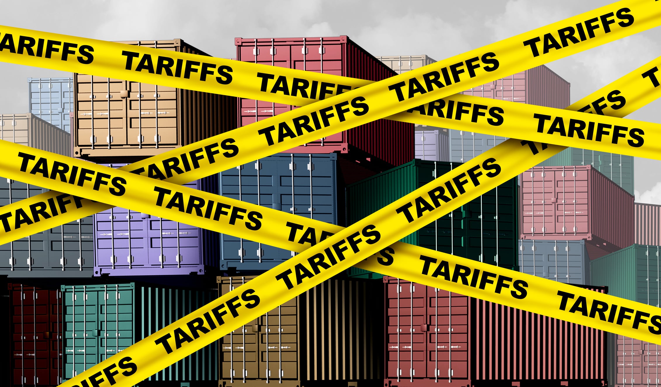 Yellow tape with tariffs written on it across shipping containers.
