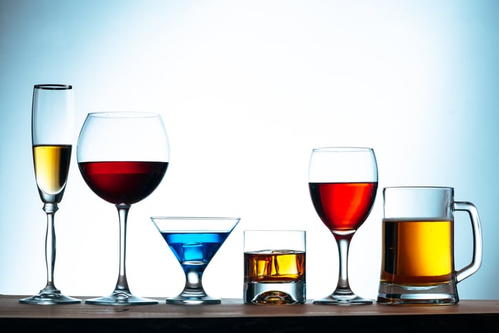 assortment of alcoholic beverages and glasses