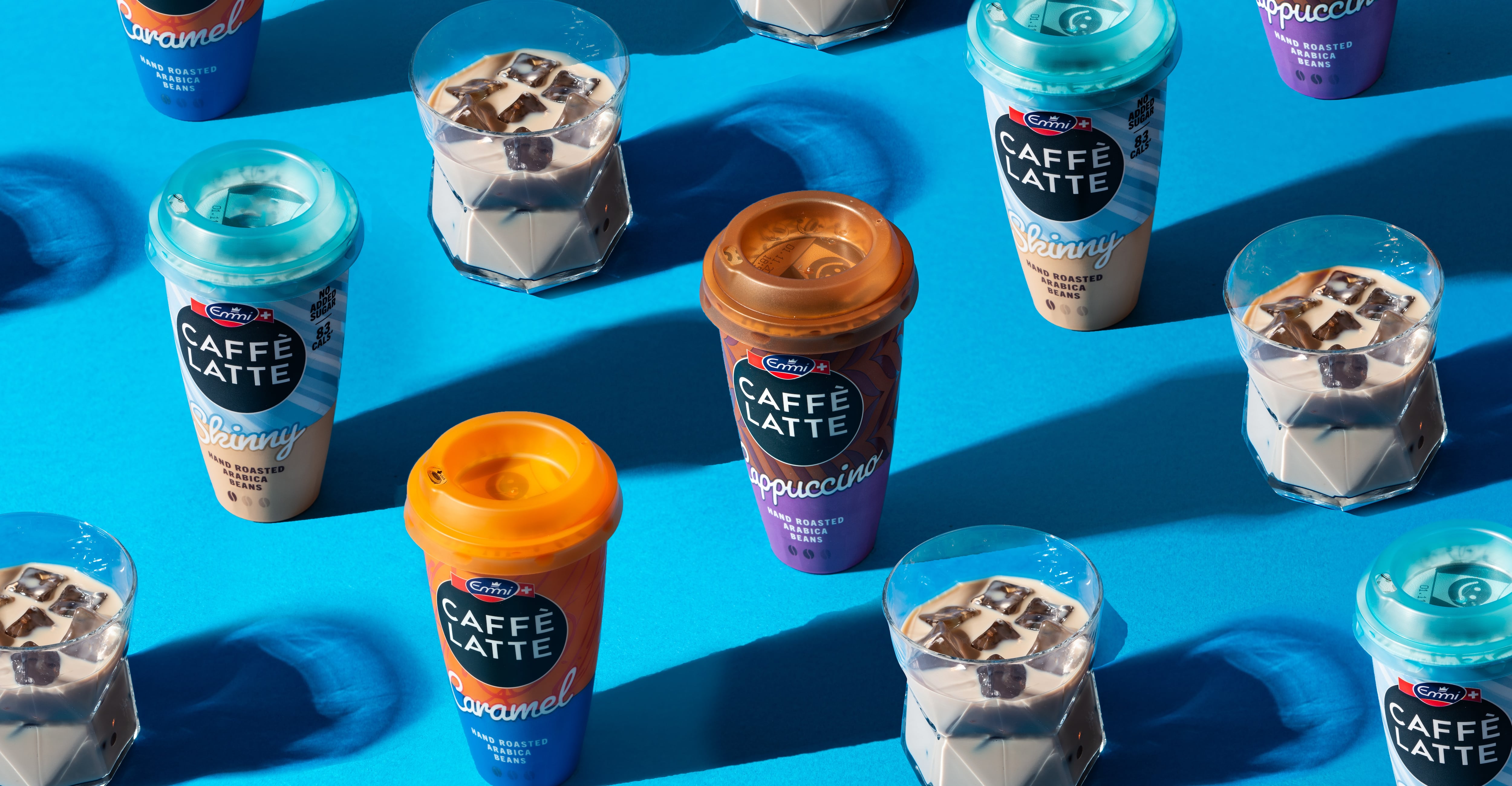 RTD iced coffee on a blue background poured into glasses