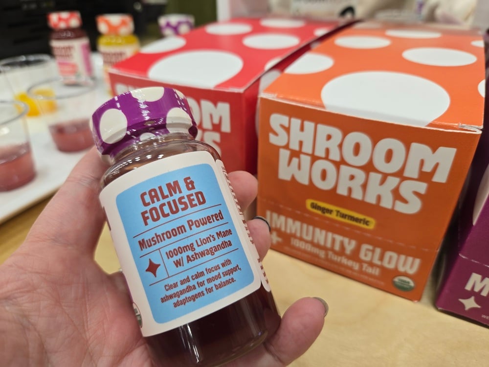 Shroomworks co-founder Shawn Dunn displays the company’s functional mushroom wellness shots, including Immunity Glow (turkey tail), Mental Magic (lion’s mane), and Inner Energy (cordyceps).