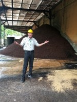 CEO Tom Clemente stands in front of a mound of discarded coffee cherries in Colombia ©The Coffee Cherry Co.